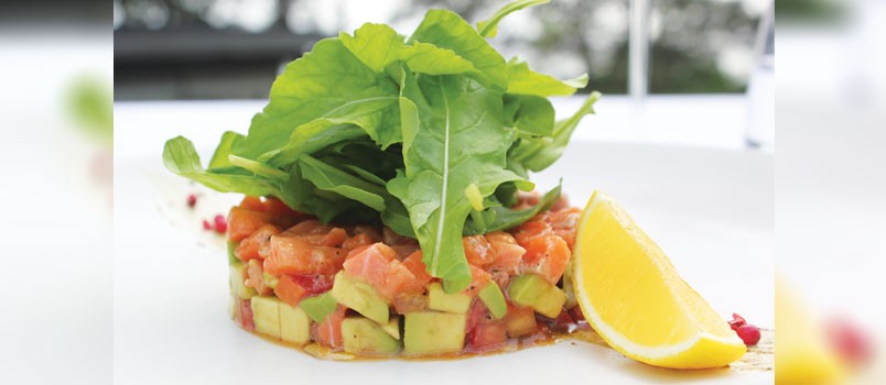 Norwegian Salmon Tartar by Chef Davide Pritoni at SALA Phuket Restaurant, Mai Khao — fresh salmon layered with avocado, tomato, and arugula.