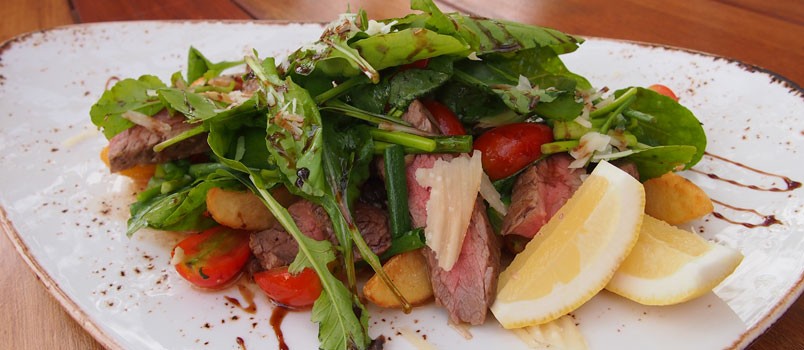 Beef Tagliata by Chef Pichet Kitkha at MINT Restaurant, Karon — grilled steak with rocket, parmesan, cherry tomatoes, and potato wedges.
