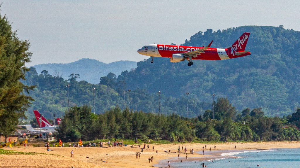 Wide-angle shot of Mai Khao Beach showing long uninterrupted coastline and open sea horizon.