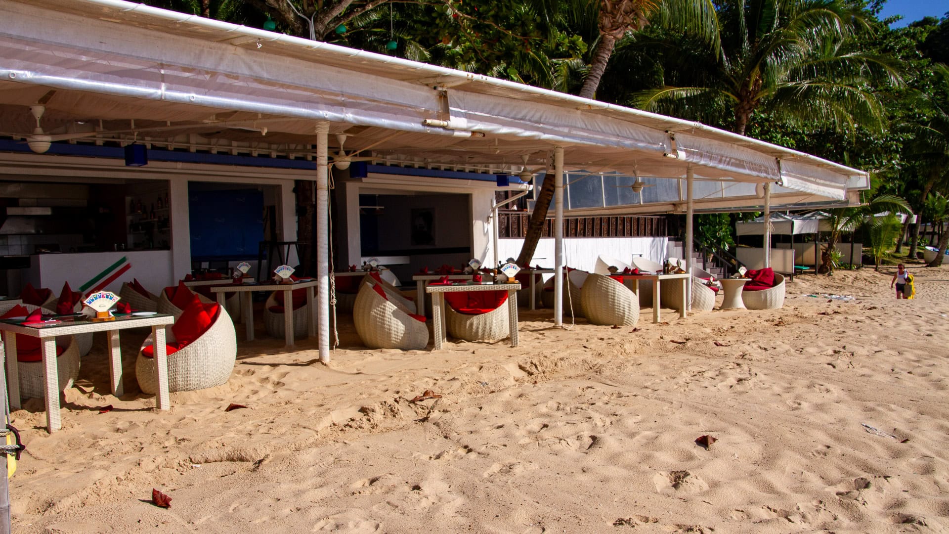 White Beach Phuket hillside resort buildings above tropical trees and calm bay below.