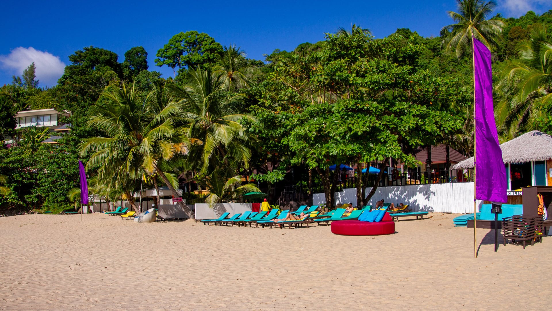 White Beach Phuket resort sunbeds and parasols set above the sand.