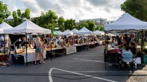 Fun Friday Boat Avenue Market Phuket with food stalls set up on a parking lot, tables covered with prepared food and no cars present