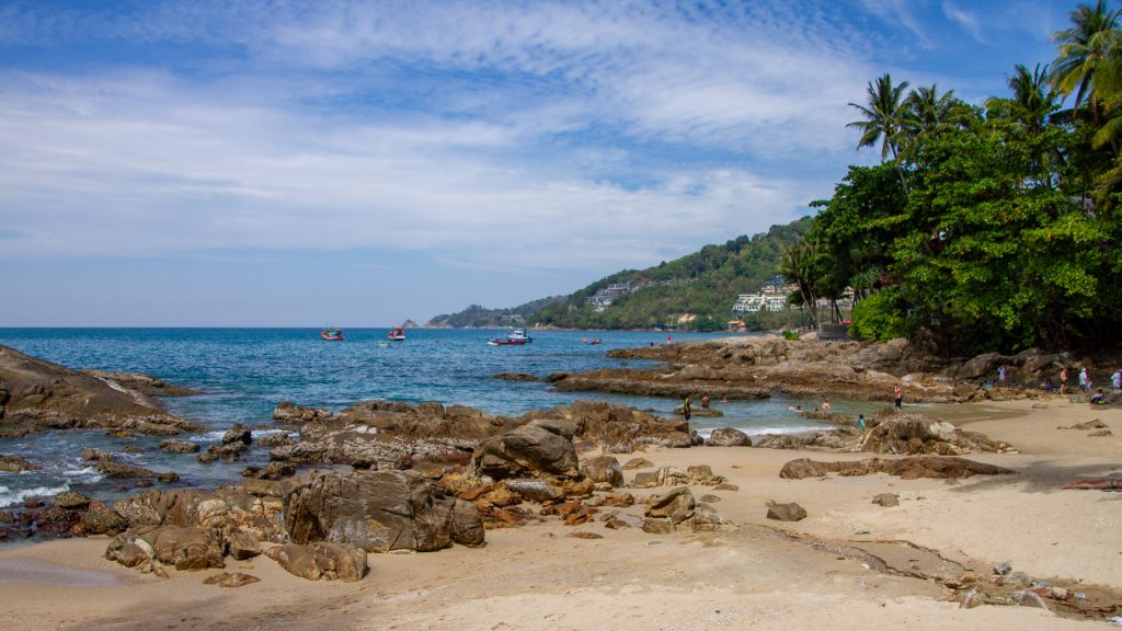 Kalim Beach Phuket coastal rocks with distant hills and blue sky