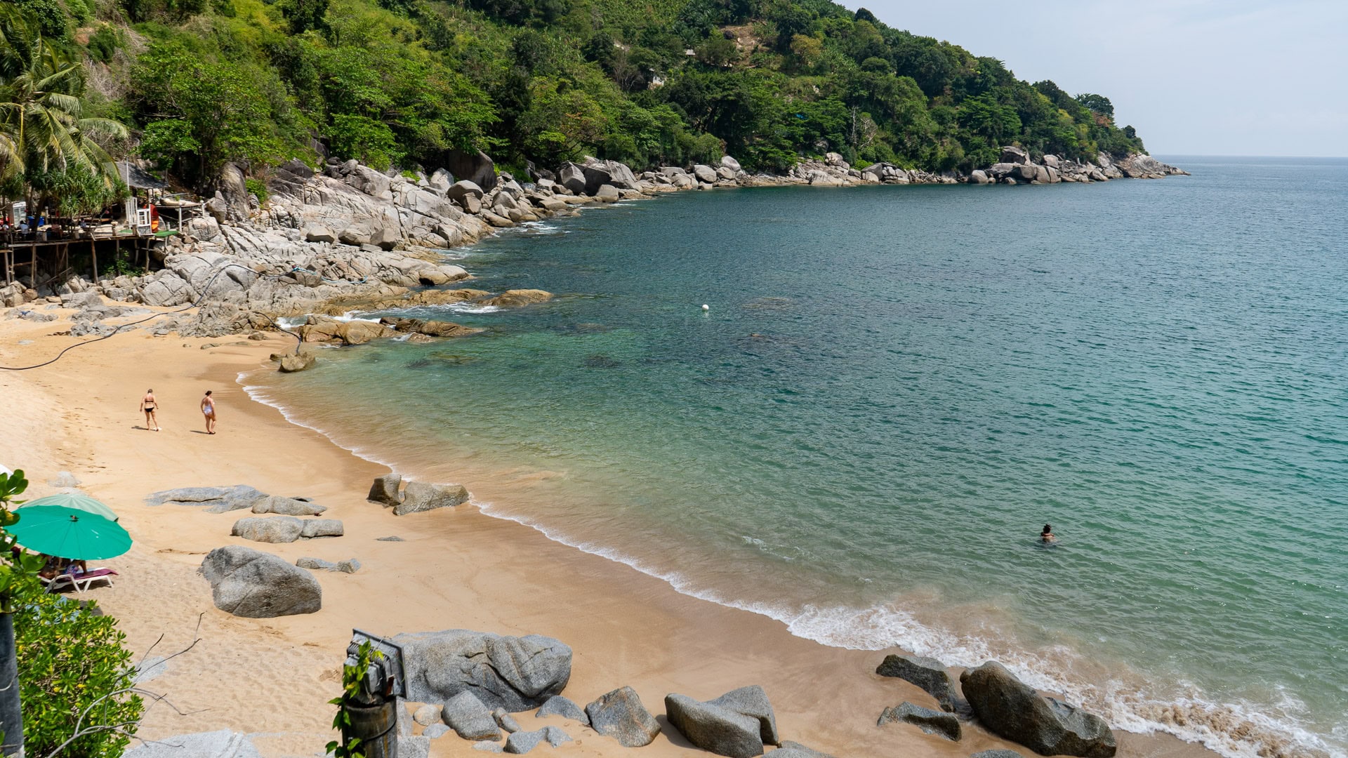 Nui Beach Phuket seating deck overlooking the sea and rocky coastline