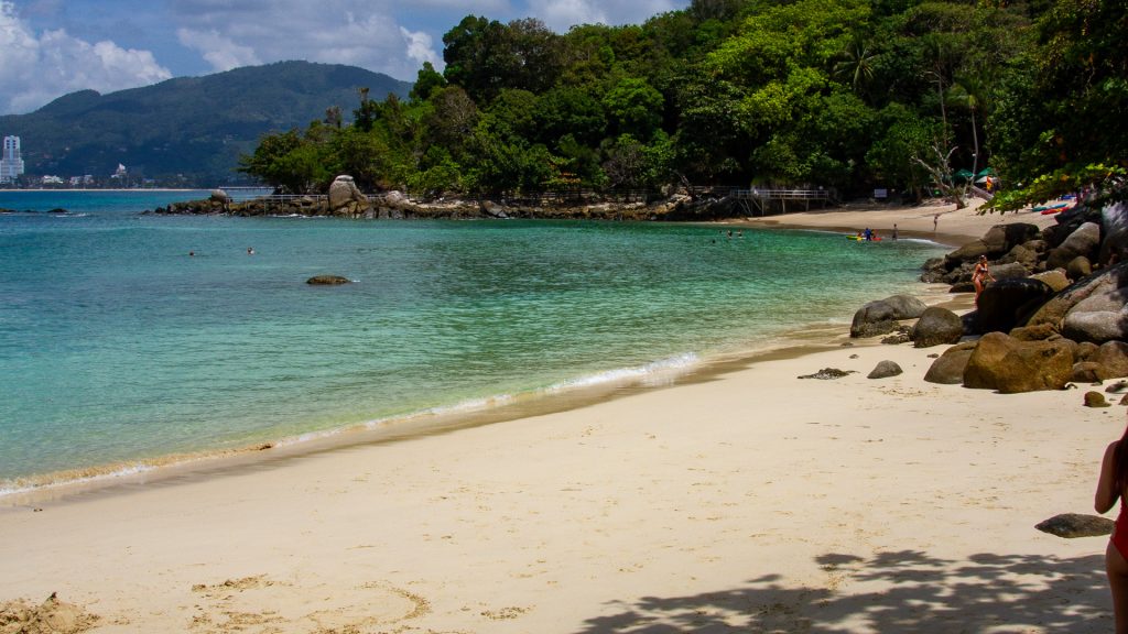 Paradise Beach Phuket wide sandy area with gentle waves and rocks