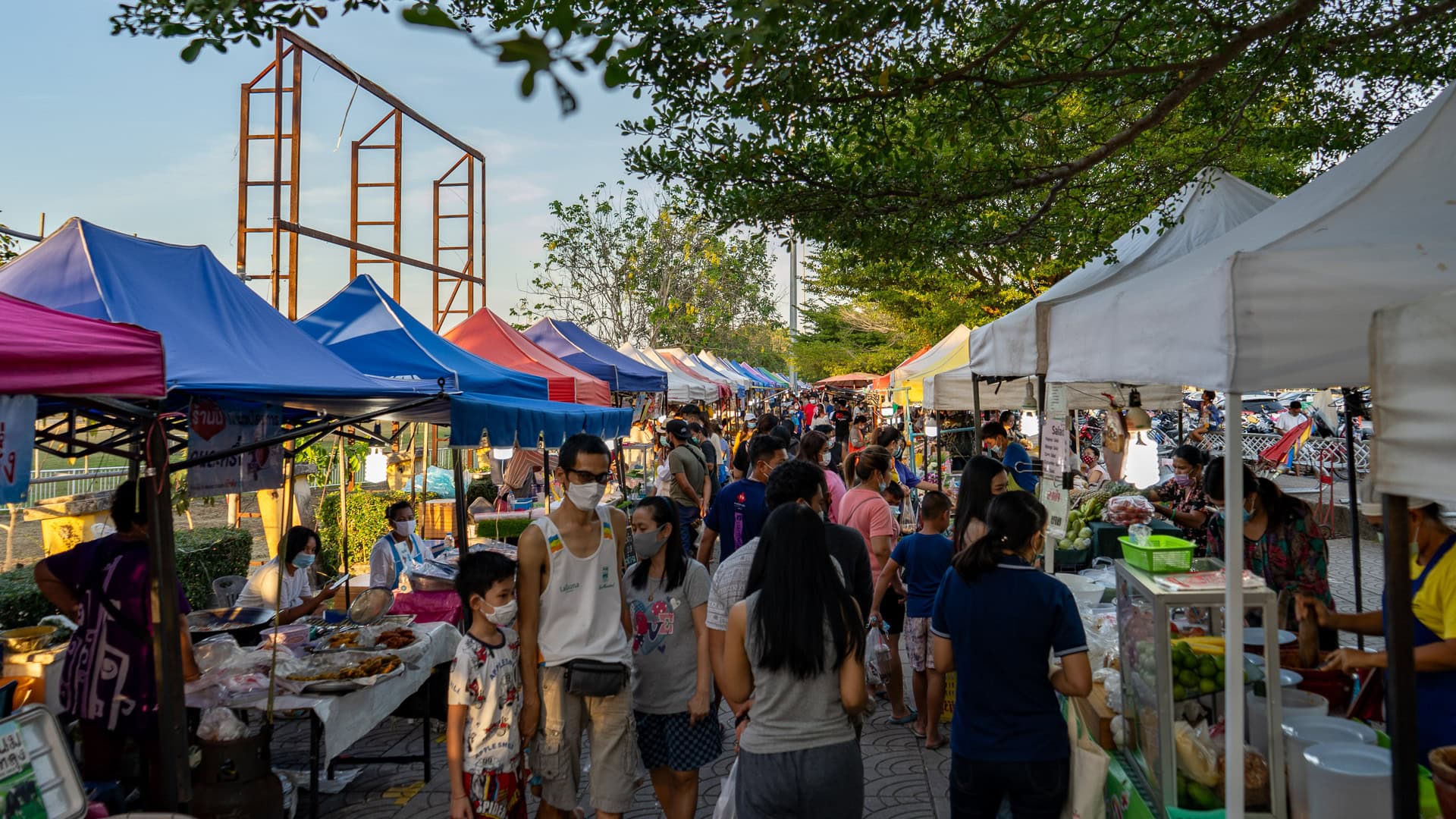 Chaeng Talay Street Food Market with crowded evening walkways, rows of vendor tents, and people moving between food stalls.