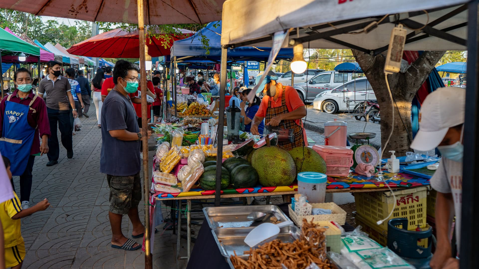 Grilled meat and skewers served at Chaeng Talay Street Food Market, with customers ordering takeaway food.