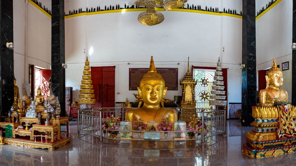 Full interior view of hall with half-buried Buddha at Wat Phra Thong