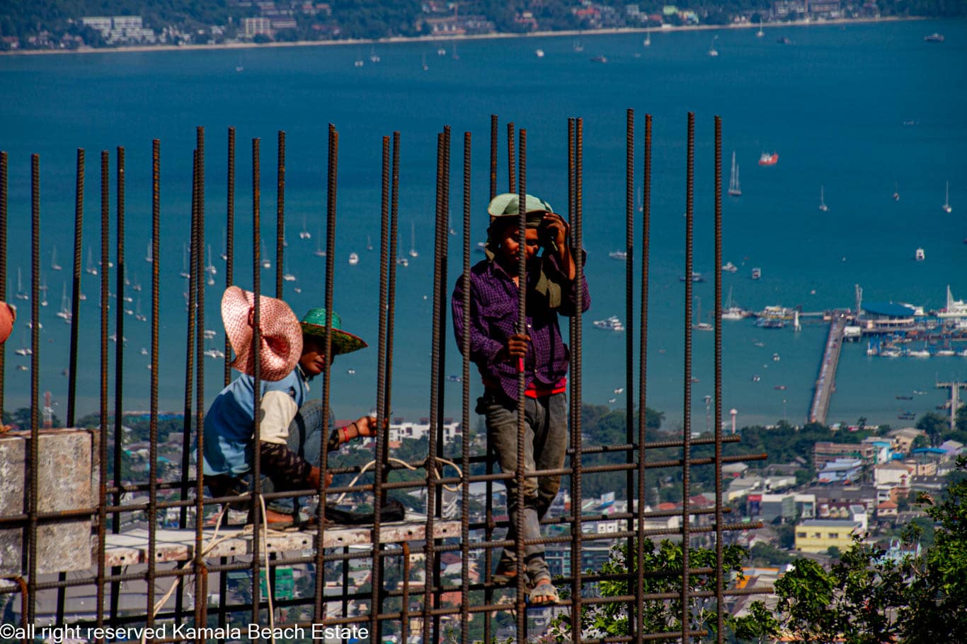 Construction workers tying rebar above Chalong Bay at Big Buddha Phuket