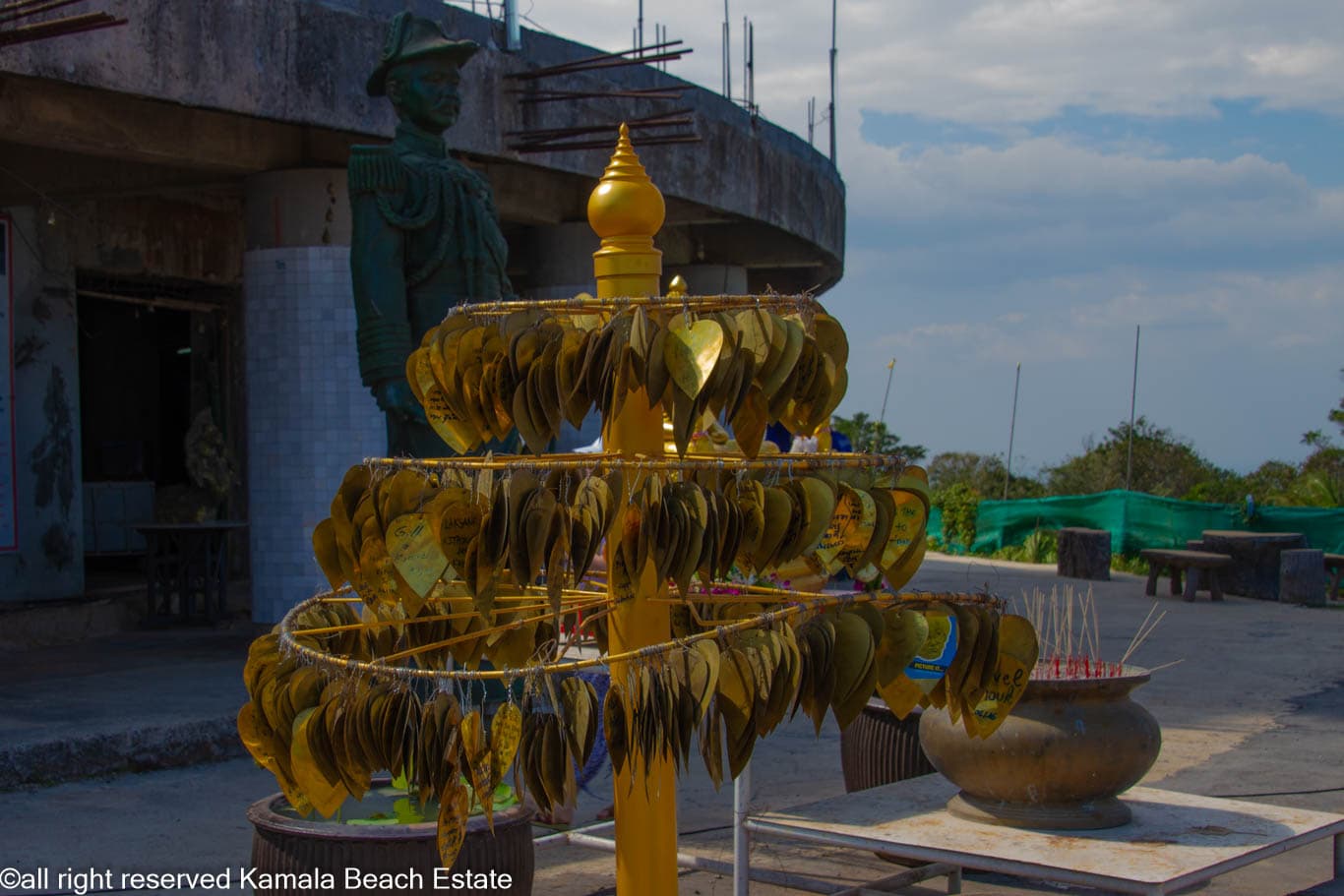 Inscribed golden leaf plaques beside an incense pot at Big Buddha Phuket