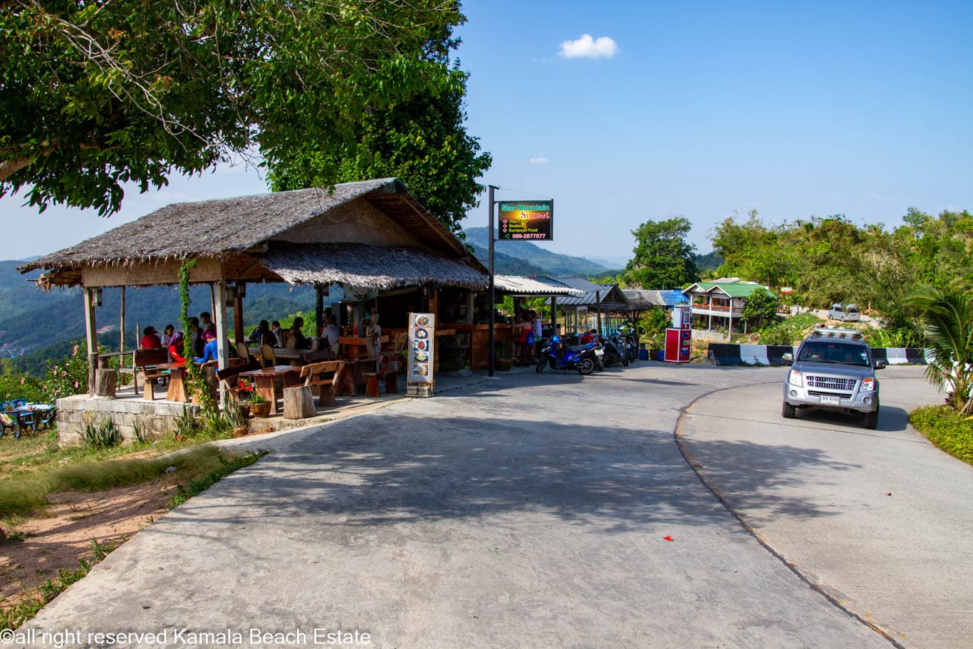Steep road and roadside café on the approach to Big Buddha Phuket