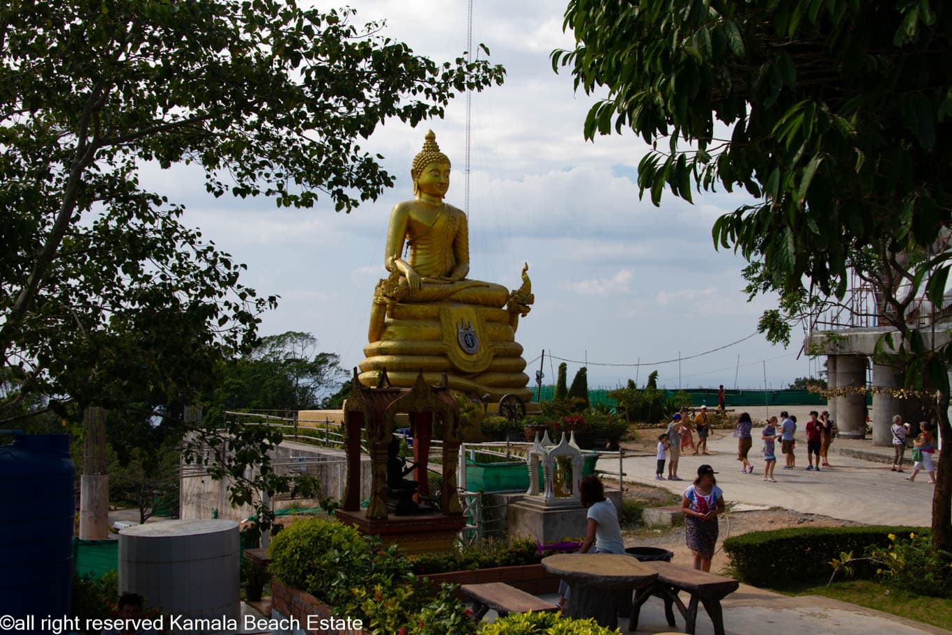 Golden seated Buddha in the grounds at Big Buddha Phuket