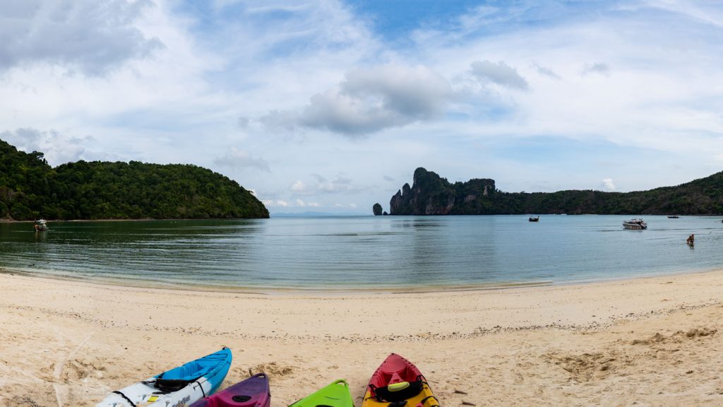 Kayaks on a sandy beach with limestone cliffs off Phi Phi Don