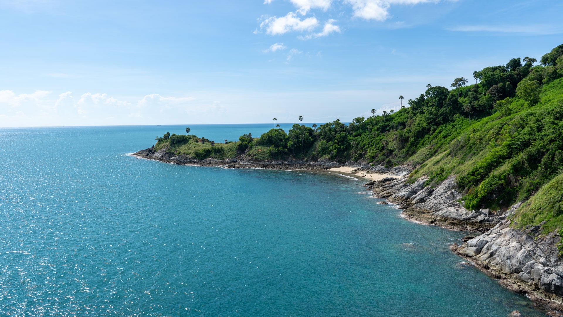 Blue water and green coastline viewed from Promthep Cape