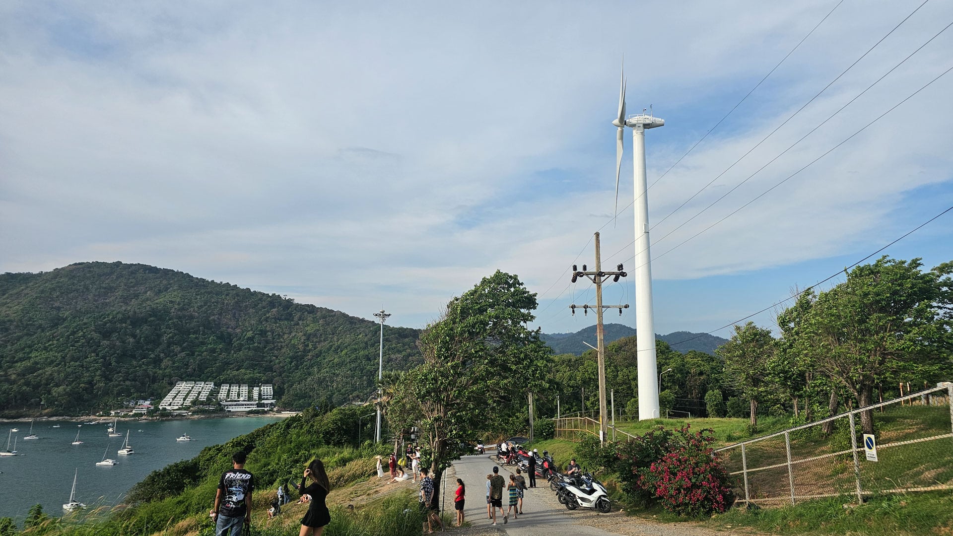Wind turbine and visitors at Windmill Viewpoint above Nai Harn