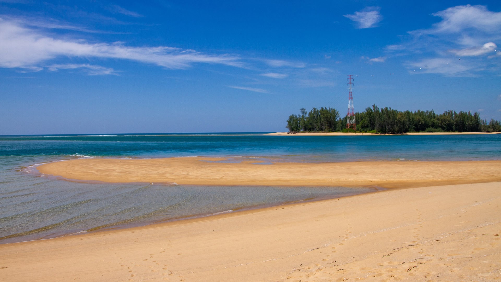 Sandbank and tidal flats at Haad Pak Phra Beach, Mai Khao, Phuket, facing the Pak Phra Strait and northern headland.