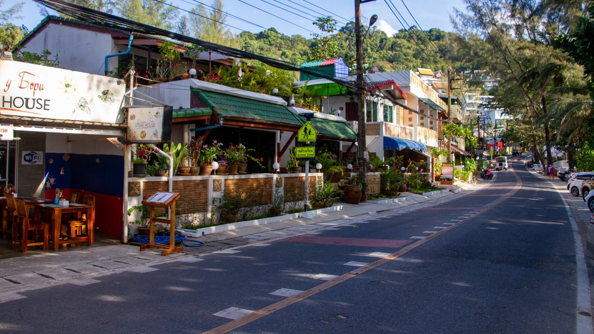 Naithon Beach Phuket small guesthouses and restaurants lining the gently curving village road behind the beach.