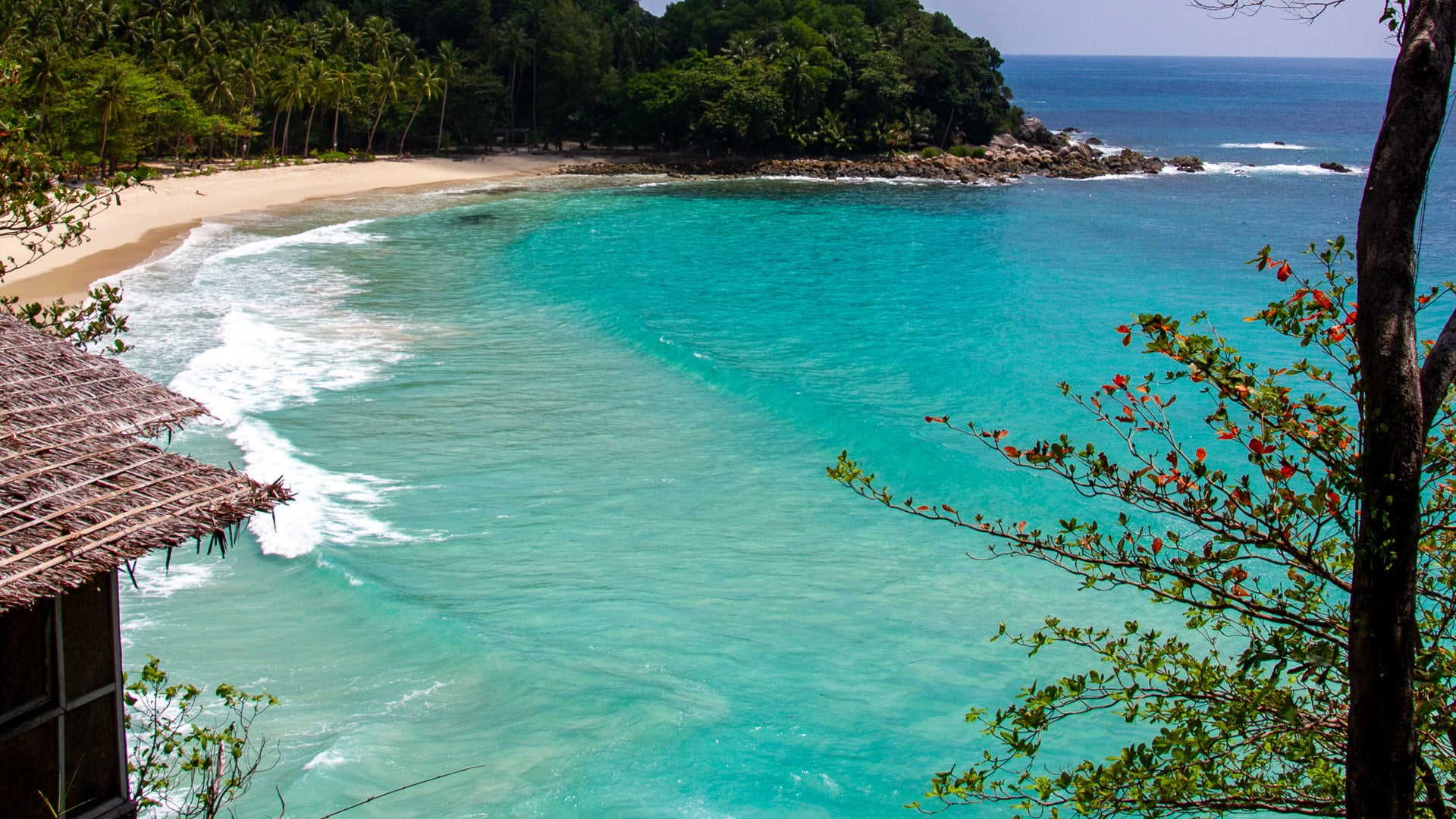 Freedom Beach Phuket cove with turquoise water and curved white sand shoreline