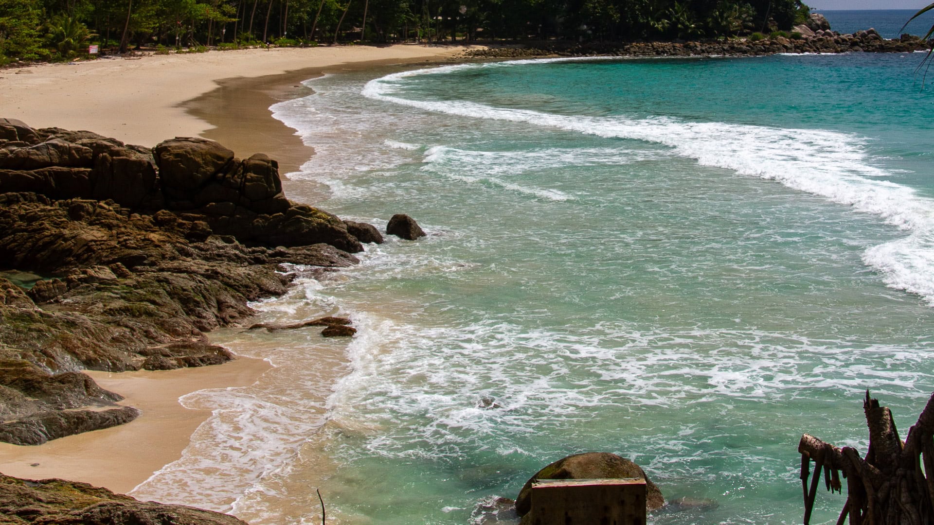Freedom Beach Phuket with rocks along shore and small waves