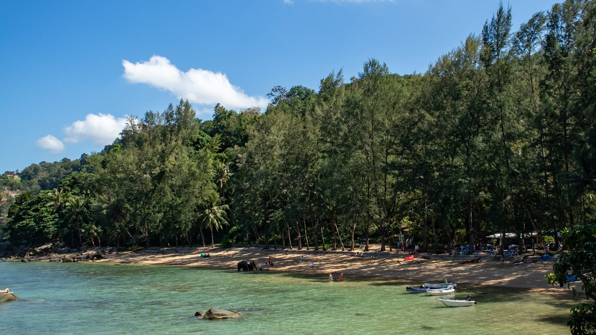 Hua Beach Phuket long shaded shoreline with calm sea and trees