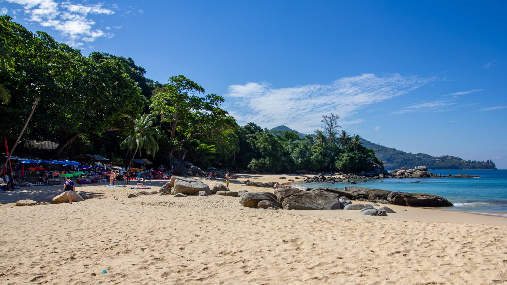 Nearshore rocks and gentle wave action at Laem Singh Beach Phuket during calm season.