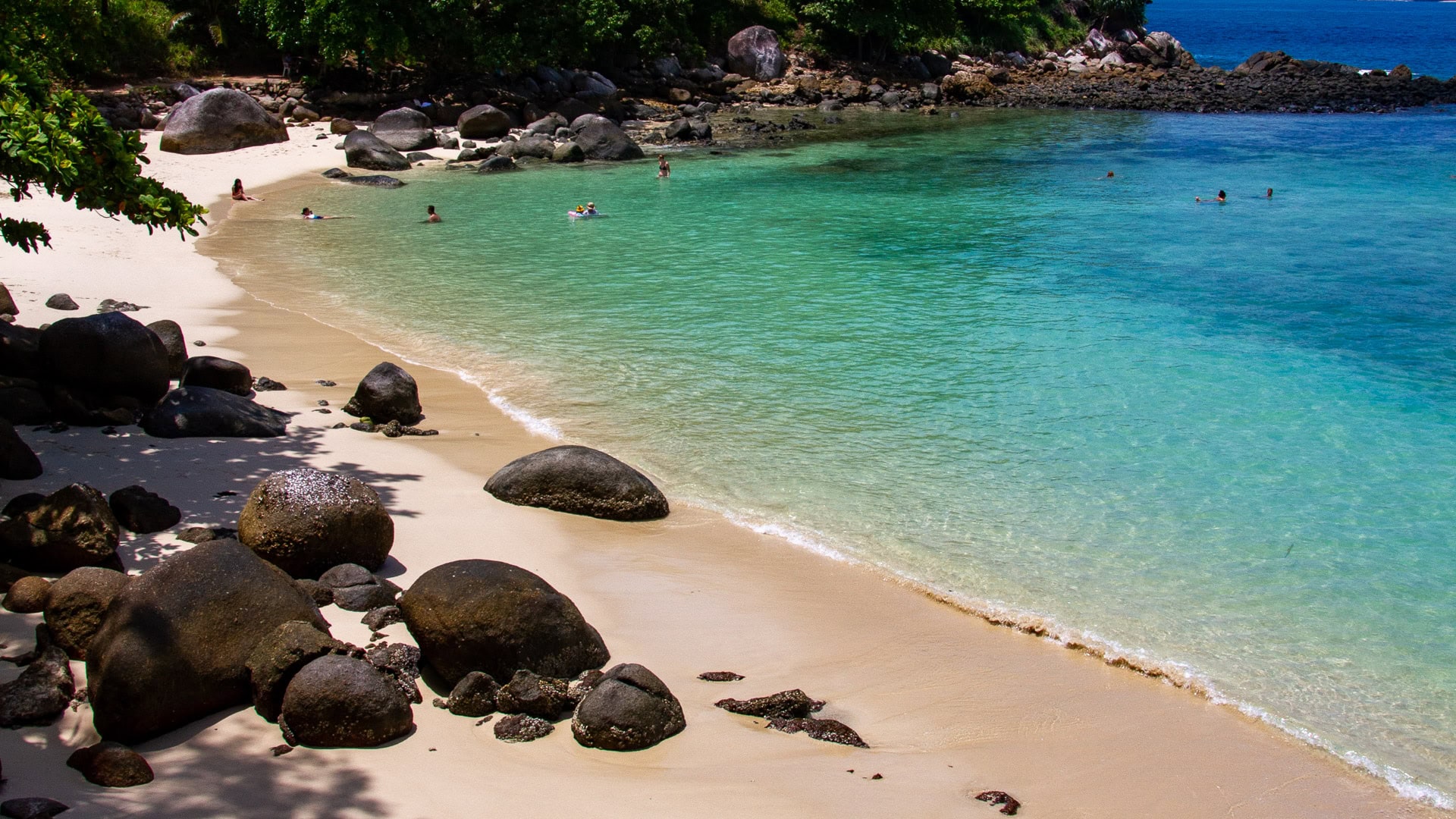 Paradise Beach Phuket small cove with granite rocks and clear shallow water