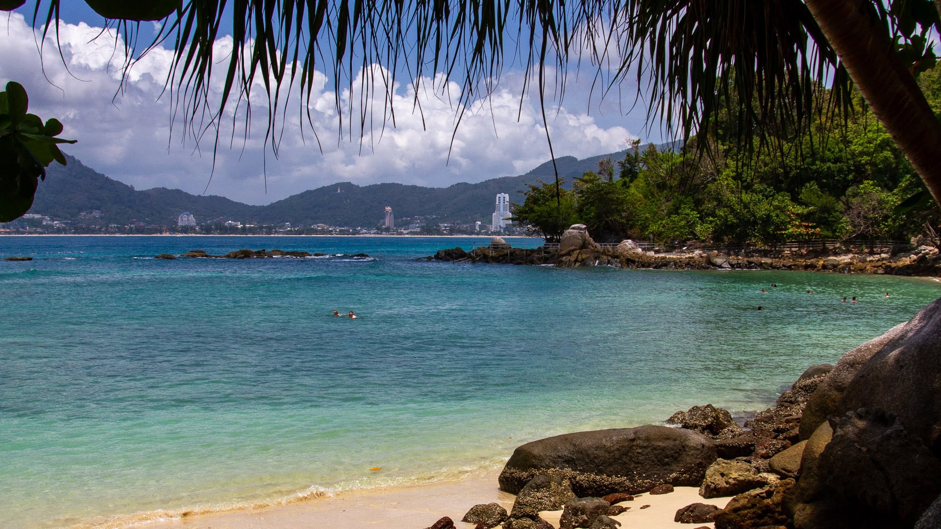 Paradise Beach Phuket view toward Patong Bay from shaded beach edge