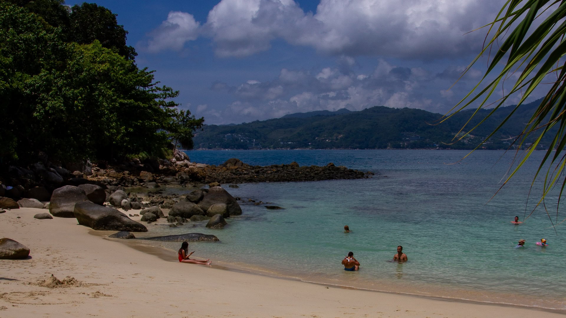 Paradise Beach Phuket calm bay with people swimming near shore