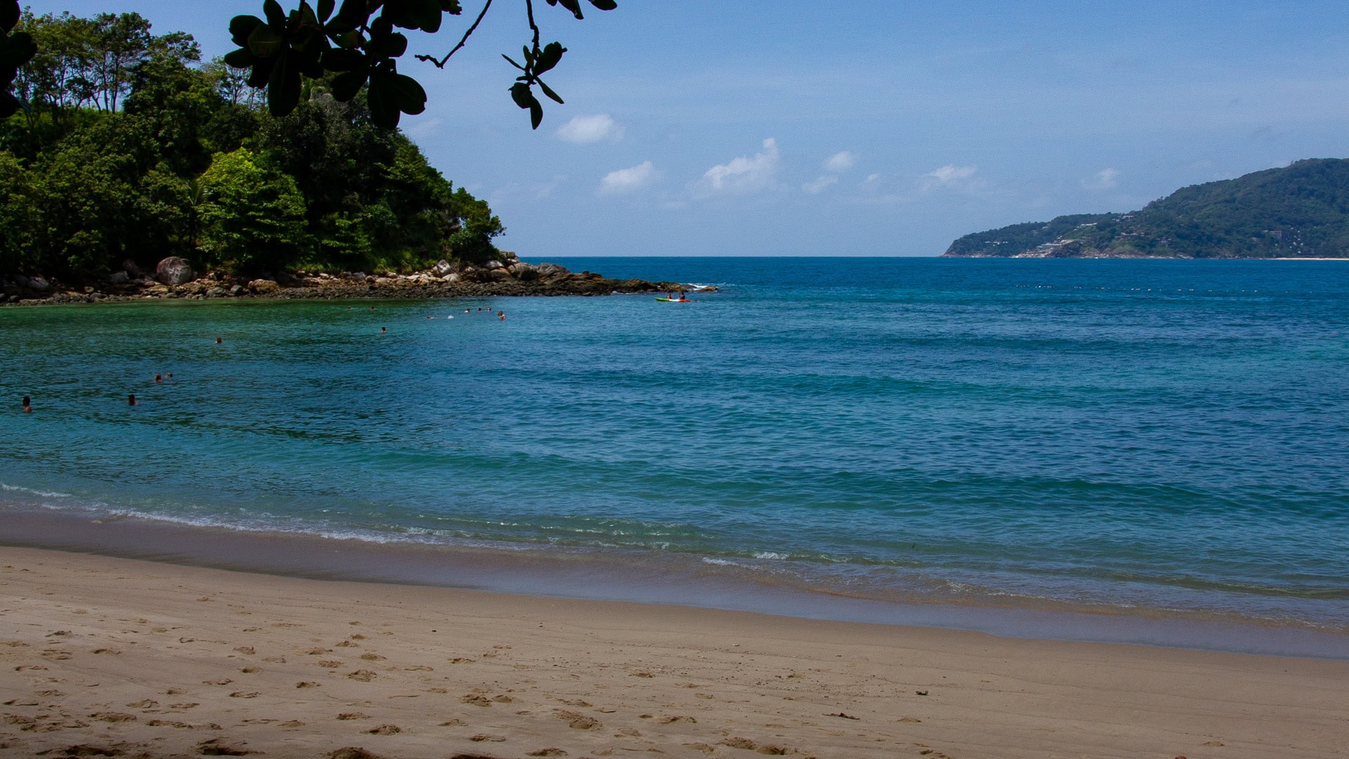Paradise Beach Phuket shallow water and forested headland backdrop