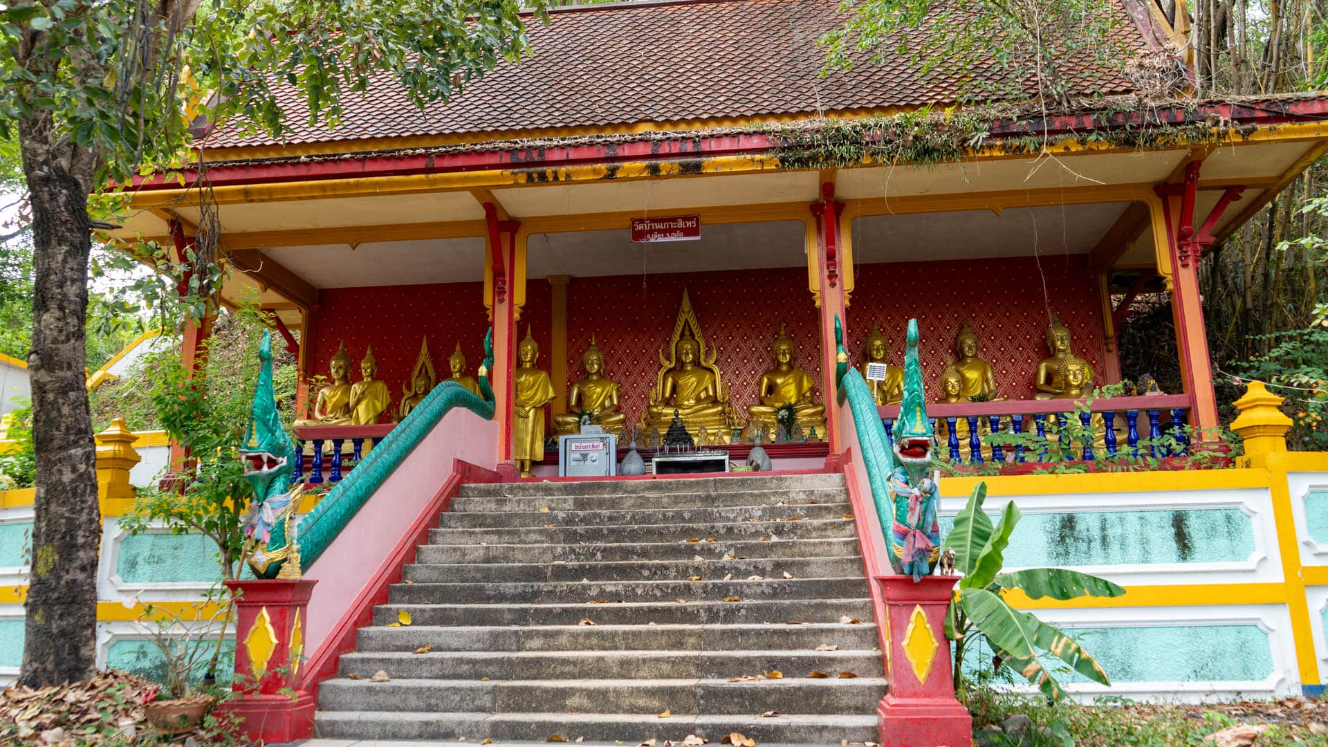 Temple staircase with naga balustrades leading to shrine pavilion at Wat Ban Koh Sirey