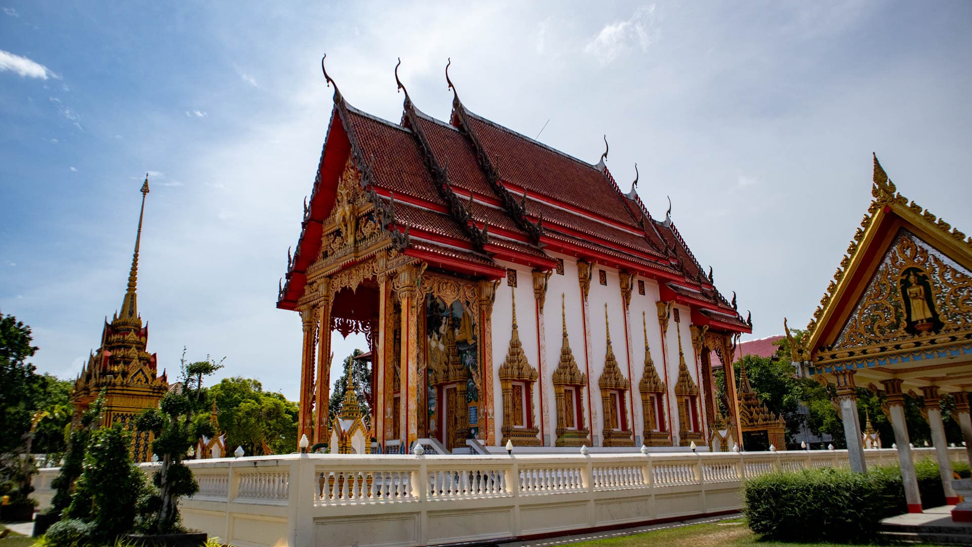 Wat Chalong ordination hall with red tiled roof and ornate temple decoration