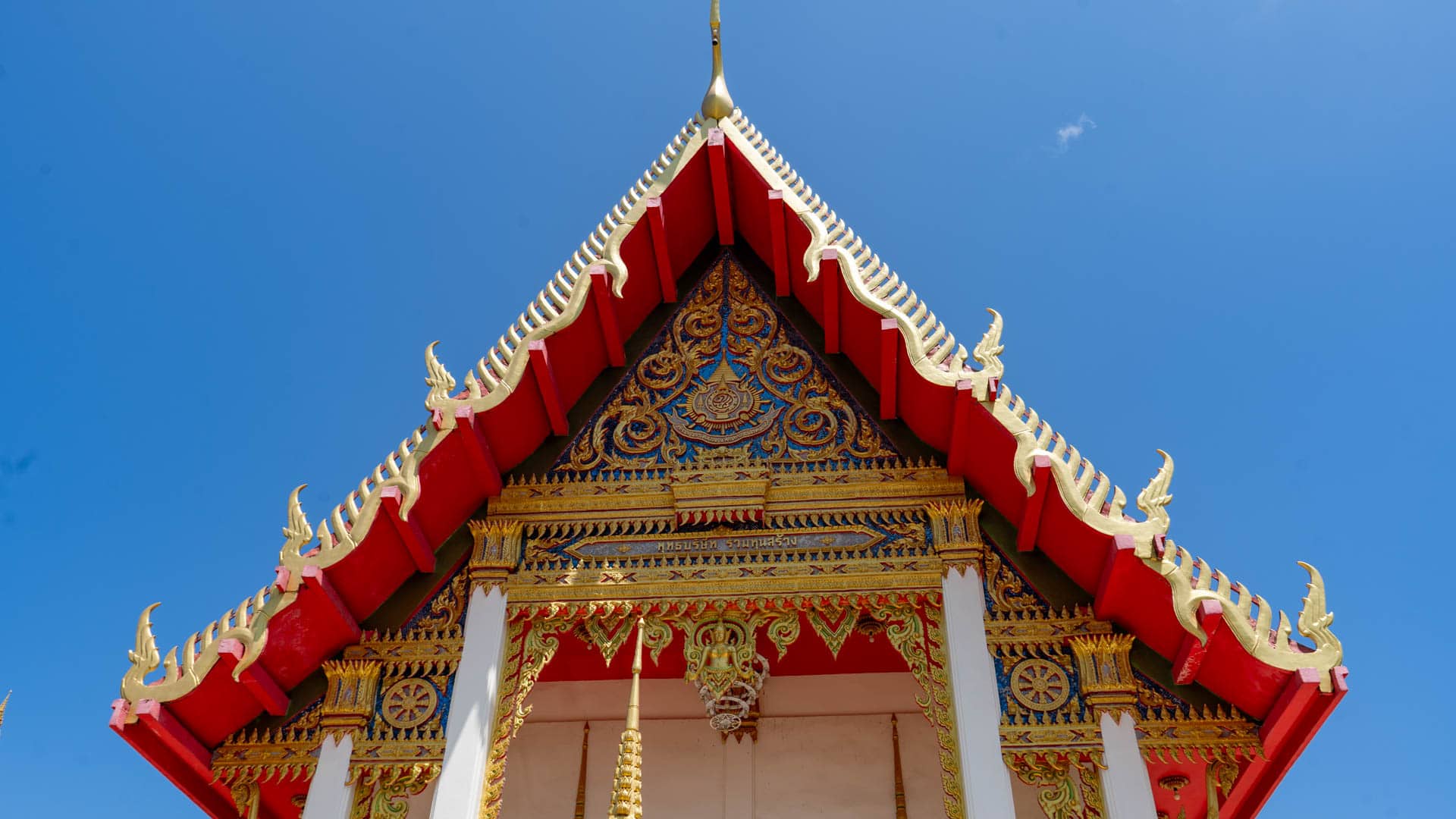 Decorated temple roof gable with gold ornament at Wat Karon Phuket